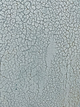 Close-up of a cracked surface. Blue-gray painting