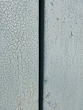 Close-up of a cracked surface. Blue-gray painting