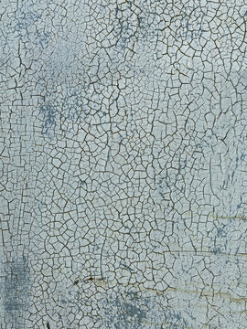 cracked surface of a blue-gray painting