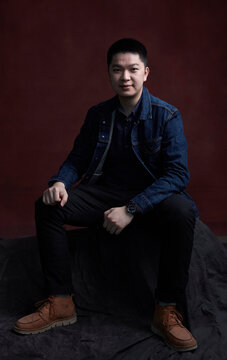 Portrait of young Asian man, indoors.