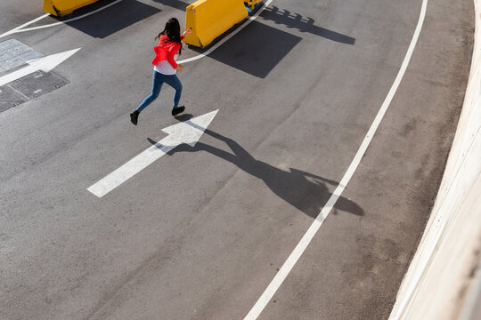 Woman running On parking entrance