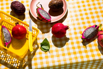 Fruit on checkered tablecloth hard shadows. Tropical foods
