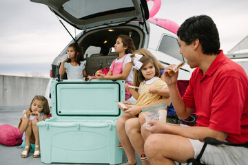 Family Of 6 On A Road Trip, Stopped And Eating A Snack Or Meal