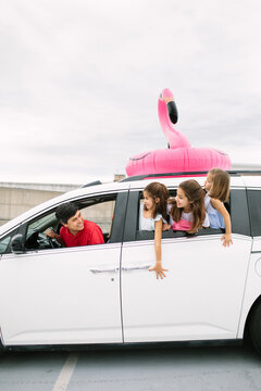 Dad And Daughters Leaning Out Of Car Window, Going On A Trip
