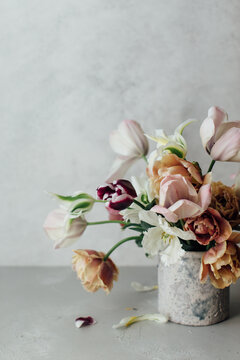 Tulips in vase on concrete surface
