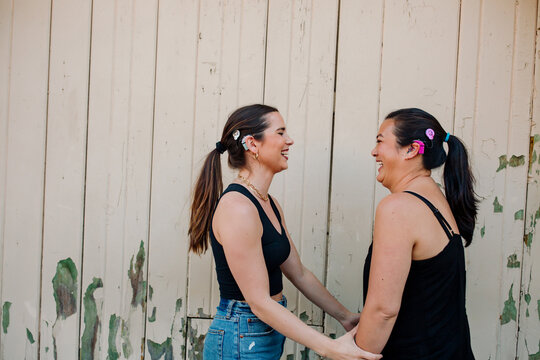 Deaf girlfriends laughing together