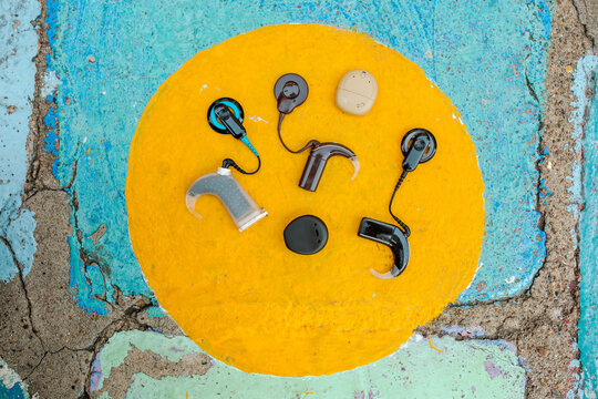 Cochlear implants in painted yellow circle