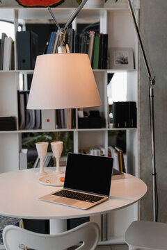 Netbook on white table in coworking space