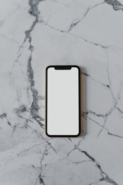 Modern smartphone with empty screen on table