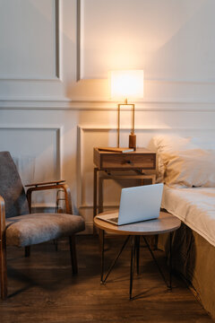 Cozy bedroom with laptop on table