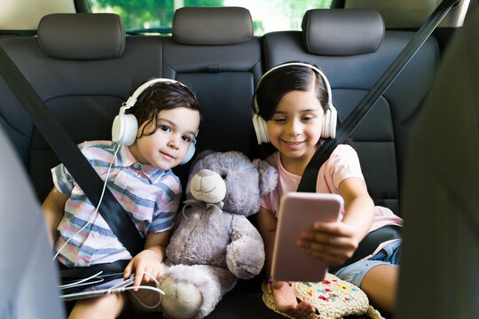 Kids watching a fun video on a road trip