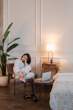 Sad woman sitting near laptop