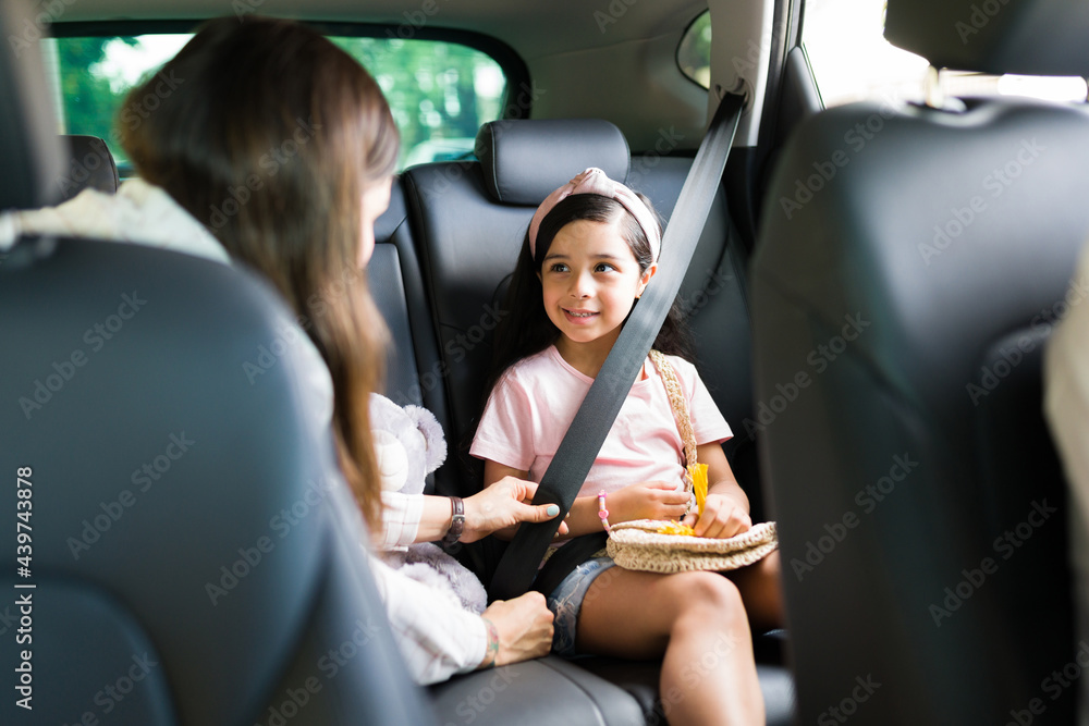 Poster young woman talking with their children in the car