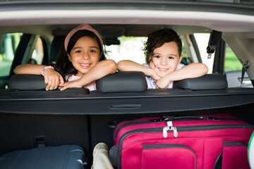Portrait of brother and sister waiting in the car