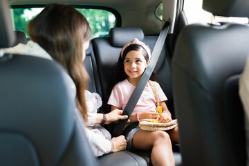 Young woman talking with their children in the car - Powered by Adobe