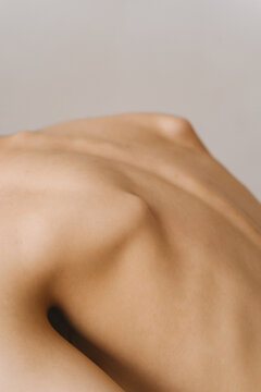 Nude female back with protruding shoulder blades