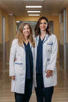 Happy confident female doctors in a hospital corridor