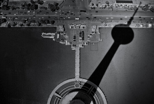 Huge tower shadow  on the city ground