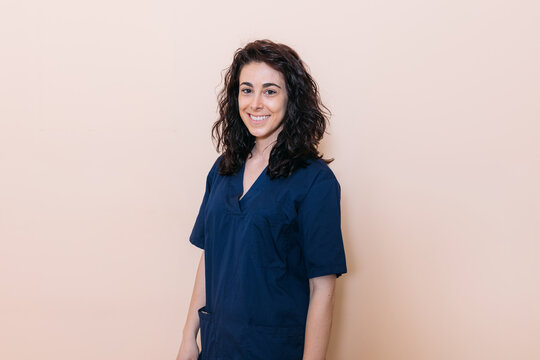 Happy confident doctor over beige background