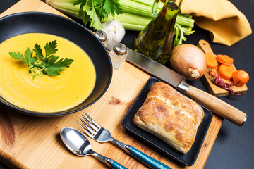 vegetable puree soup in a black bowl