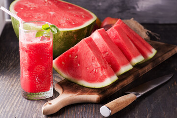 Fresh watermelon smoothie with ice in a glass.