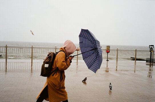 Woman in long jacket by the sea