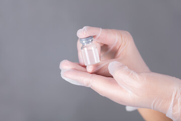 Hand holding virus vaccine close-up