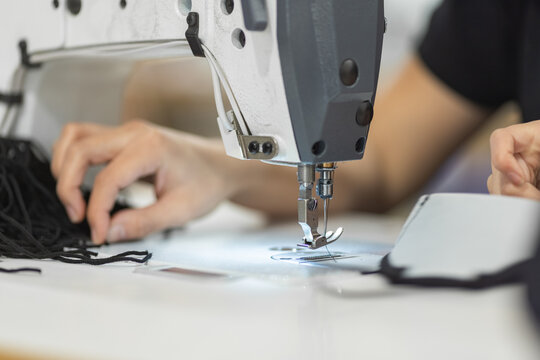 Young woman working with sewing machine