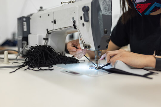 Young woman working with sewing machine