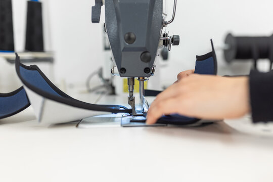 Young woman working with sewing machine