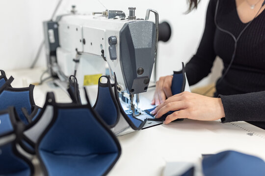 Young woman working with sewing machine