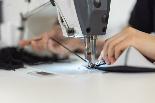 Young woman working with sewing machine