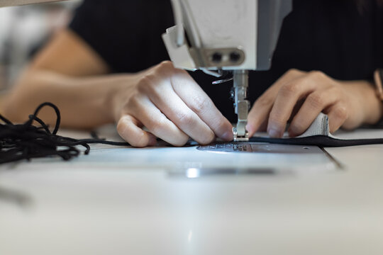Young woman working with sewing machine