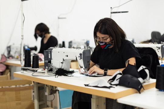 Young woman working with sewing machine