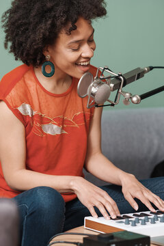 Woman Singing And Playing Keyboards In The Studio