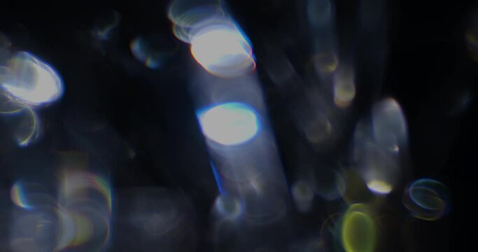 Seamlessly looped crystal reflection bokeh rainbows and orbs shot with a vintage cinema lens for use as an overlay in any NLE
