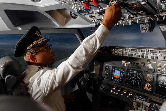 afro american pilot flying a passenger plane