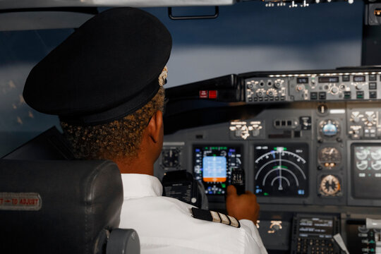 Unrecognizable black aviator steering plane