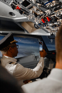 Black man taking photo of sky near copilot