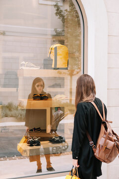 Woman in front of the store shop window