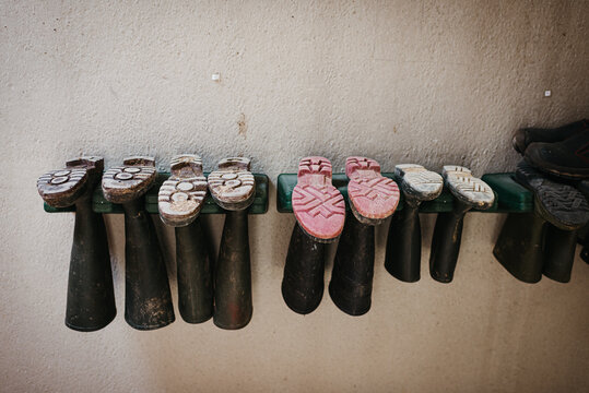 Boots hanging upside down a wall