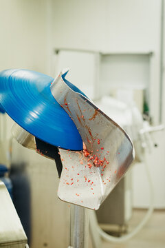Meat cutter in a factory with remnants meat