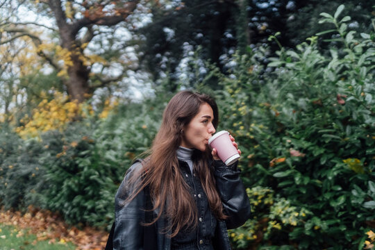 Woman Walking with Coffee in the City