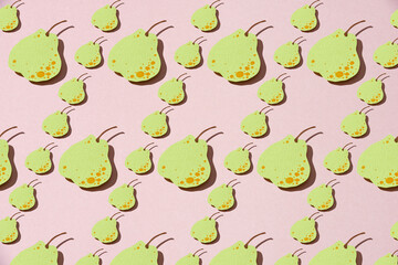 paper pears whole on pink background.