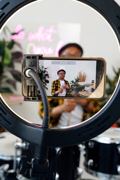 Smartphone shooting black drummer in studio