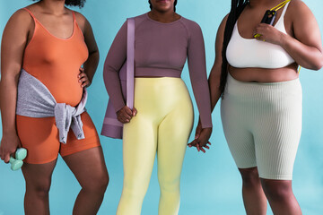 Crop black sportswomen against blue background