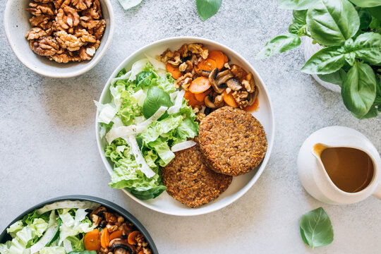 Top view of lentil patties with spicy carrots, mushrooms and fresh salad