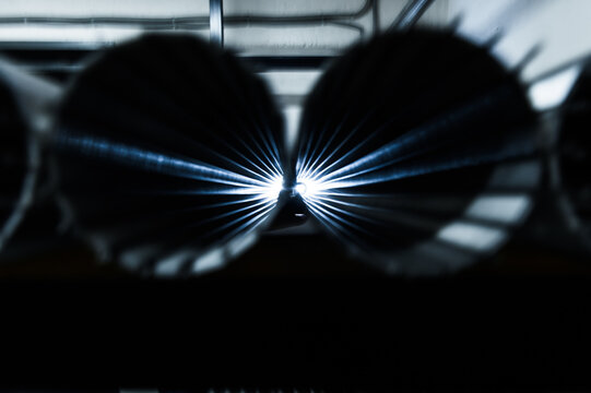 Stack of metallic tubes backlit by the flash