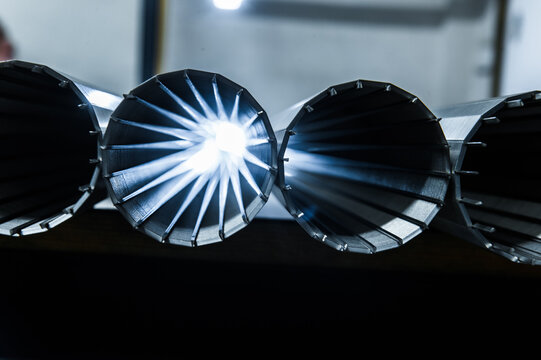 Stack of metallic tubes backlit by the flash