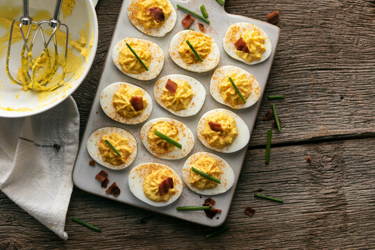 Tasty Deviled Eggs On Tray With Mixing Bowl Nearby